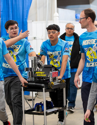 Team members preparing their robot before a match