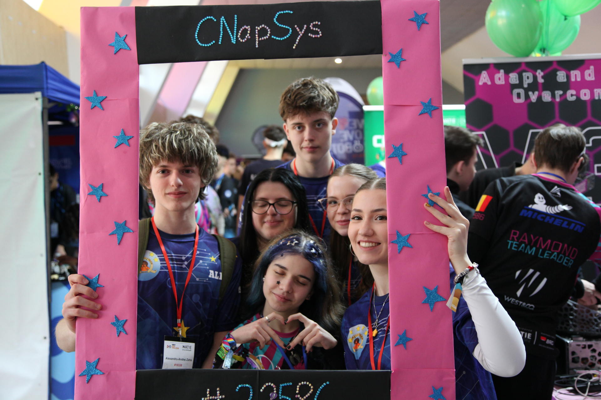 CNapSys team posing inside their pink decorated frame